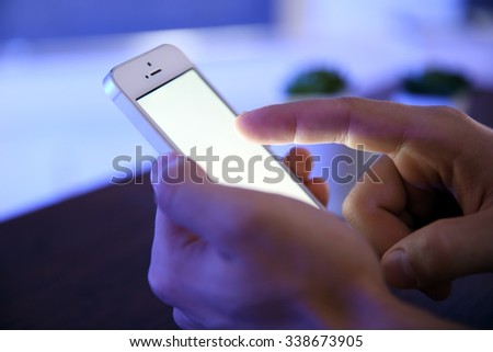 Young man using his smart phone, close up