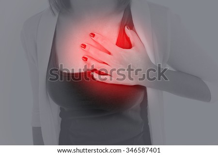 Woman having chest pain - heart attack.