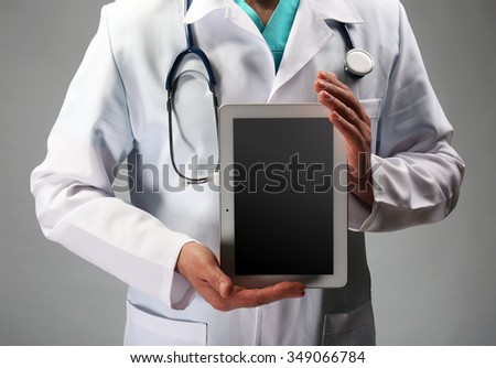 Close up view on doctor holding tablet in hands