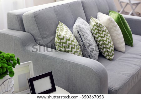 Sofa with colorful pillows in room