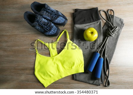 Sport clothes, shoes on wooden background