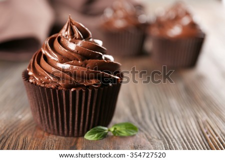 Chocolate cupcakes with mint on wooden table