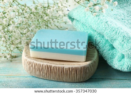 Soap on a dish over wooden background, close up