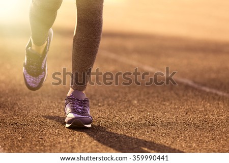 Sports woman legs in running movement