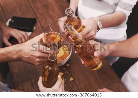 View on friends having alcoholic drinks in the bar, close-up