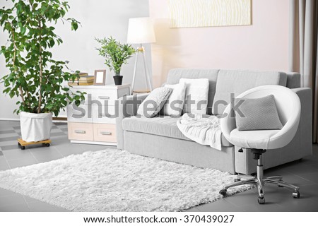 Living room design with armchair and sofa