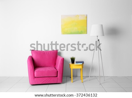Living room interior with pink armchair, lamp and yellow chair  on white wall background