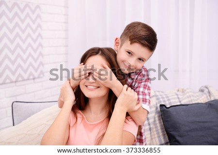 Son closing his mother eyes with his hands