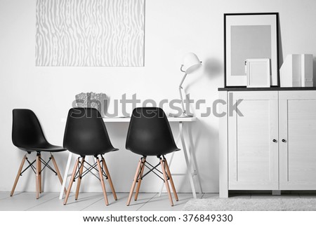 Room interior with picture, chairs and table on white wall background