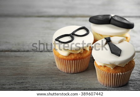 Delicious creative cupcakes on wooden table