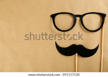 Photo booth props glasses, mustache on beige background