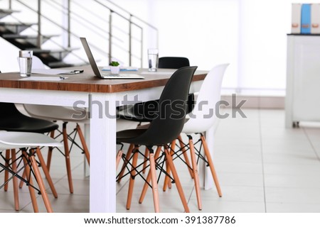Modern office. Furniture set with table and chairs. Laptop on the table