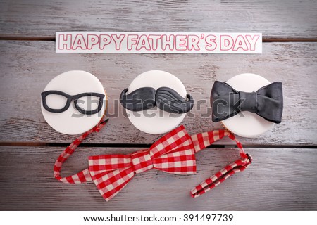 Happy fathers day special cupcakes and bow tie on wooden table