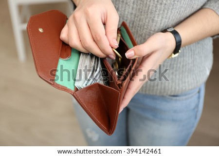 Girl with brown wallet full of money