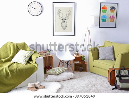 Interior of living room with green armchair and couch