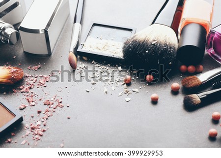 Decorative cosmetics and accessories for makeup on grey background
