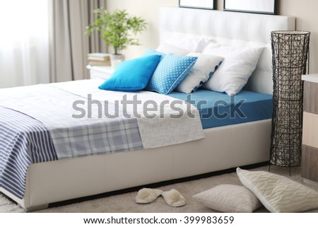 Bedroom interior in light tones with white furniture and pillows