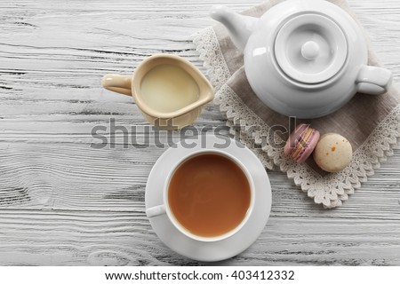 Milk tea with tea pot on white background.