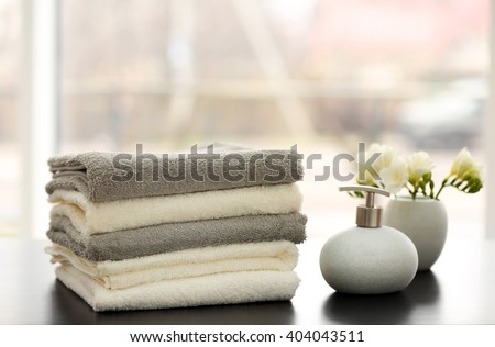 Towels and bath accessories on table