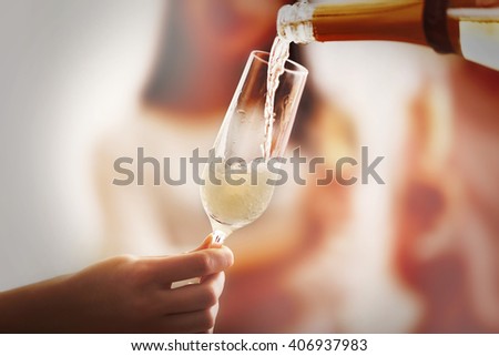 Pouring champagne into glass at hen-party, close up