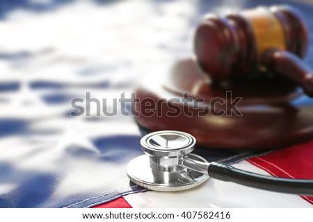 Gavel and stethoscope on national flag of USA. Forensic medicine concept