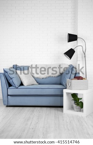Beautiful modern living room with blue sofa and floor lamp