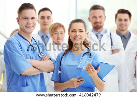 A group of doctors and nurses standing in the hospital, indoors