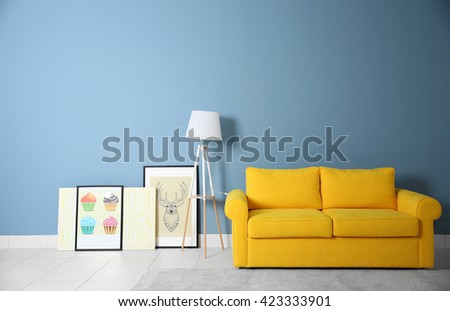Room interior with yellow sofa on blue wall background