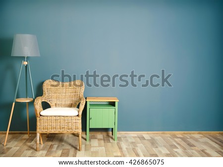 Room interior with wicker chair on dark grey wall background