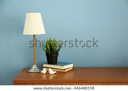 Design interior with lamp and plant on blue wall background