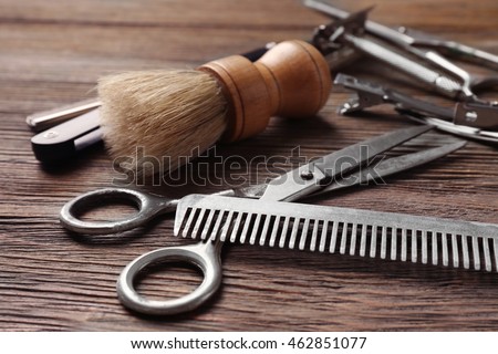 Vintage tools of barber shop on wooden background