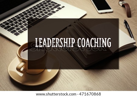 Office set on wooden table. Leadership coaching concept