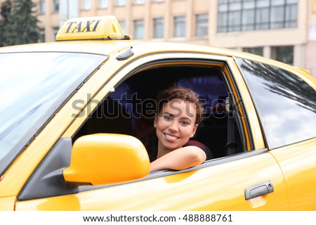 Female taxi driver in car