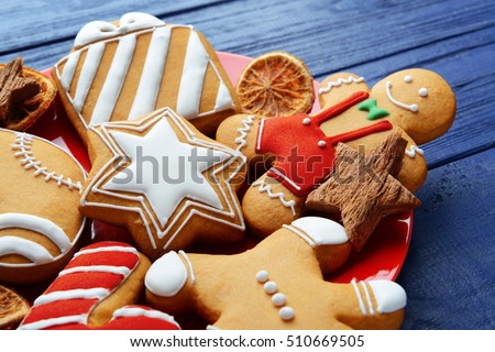 Close up view of plate with tasty Christmas cookies on wooden table