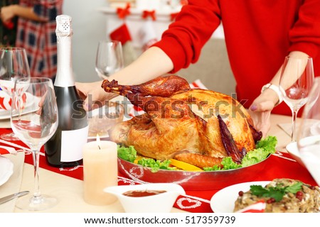 Woman serving table for Thanksgiving dinner, close up view