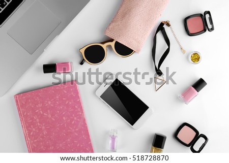 Workplace with laptop and women accessories, top view
