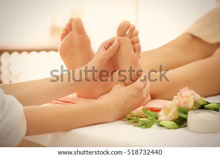 Foot massage in spa salon, closeup