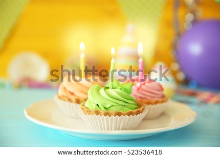 Delicious birthday cakes with candles on festive background, closeup