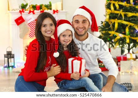 Happy family with Christmas presents in living room