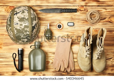 Military equipment on wooden background