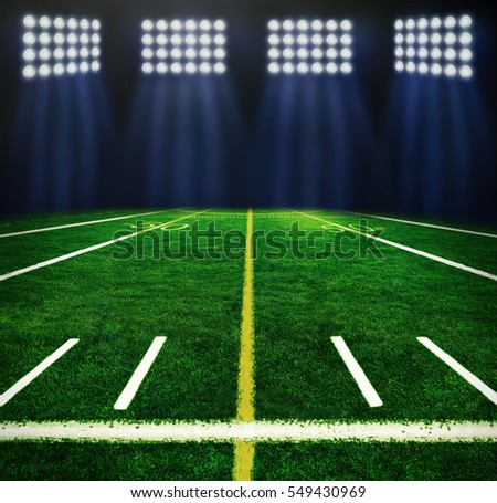 Illuminated football field at night