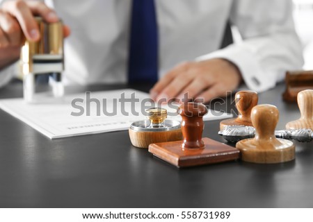 Wooden and metal stamps on notary public table