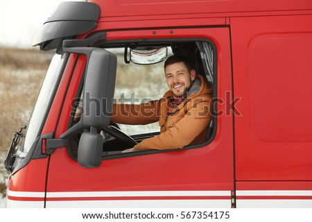 Handsome man driving big modern truck