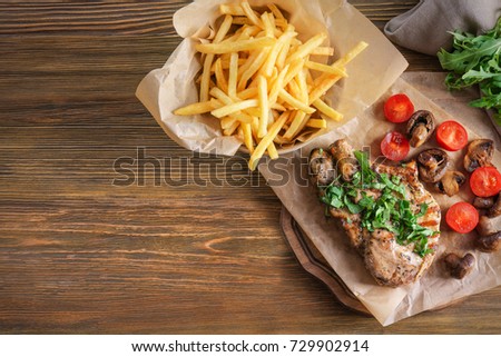 Delicious grilled steak frites on waxed paper