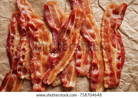 Cooked bacon rashers on parchment