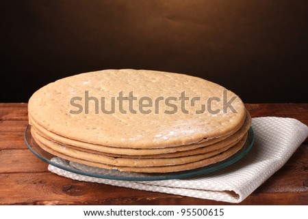 cakes for cake on glass stand  on wooden table on brown background