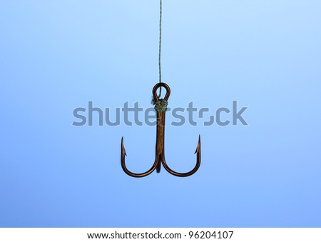 Treble fish hook on blue background