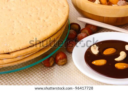 cakes for cake on glass stand and nuts on table