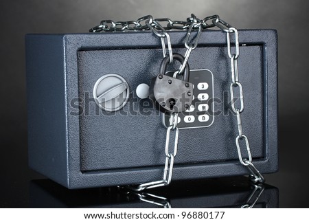 safe with chain and lock on grey background
