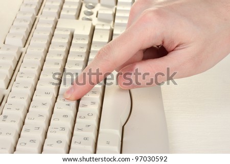 male hand typing on the keyboard isolated on white